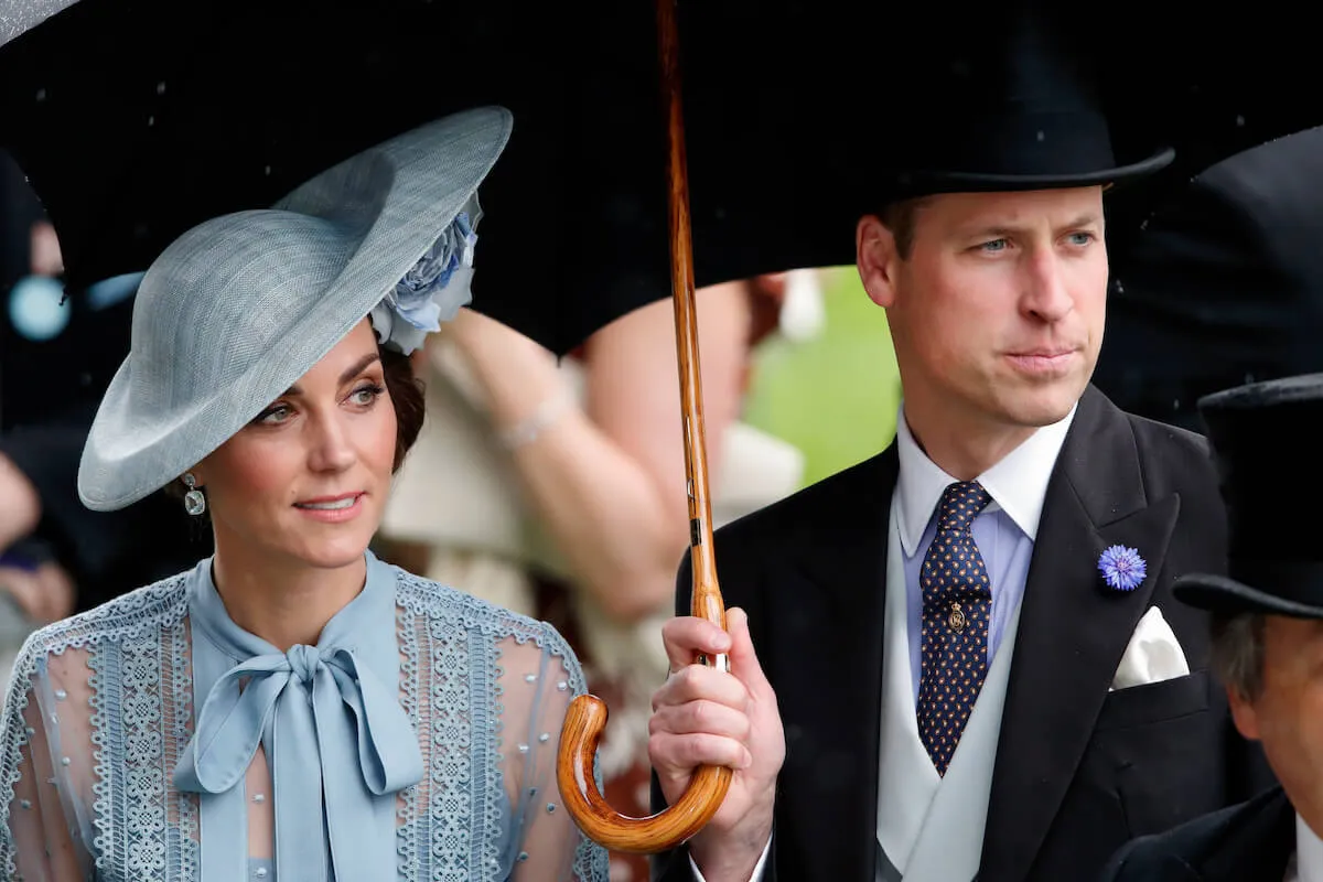Kate Middleton and Prince William, who are the 'future' of the British monarchy, stand under an umbrella