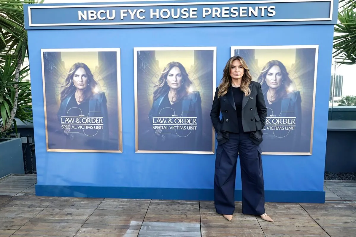 Mariska Hargitay standing in front of a 'Law & Order SVU' poster.
