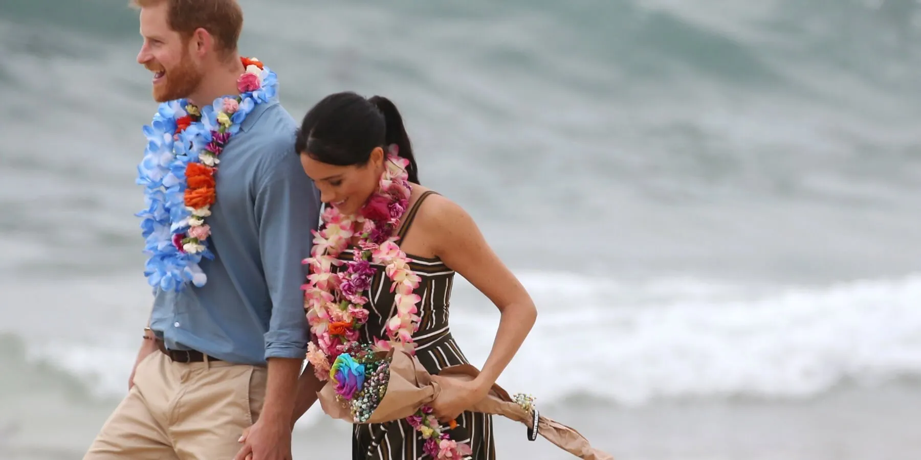 Prince Harry and Meghan Markle walk on an Australian beach