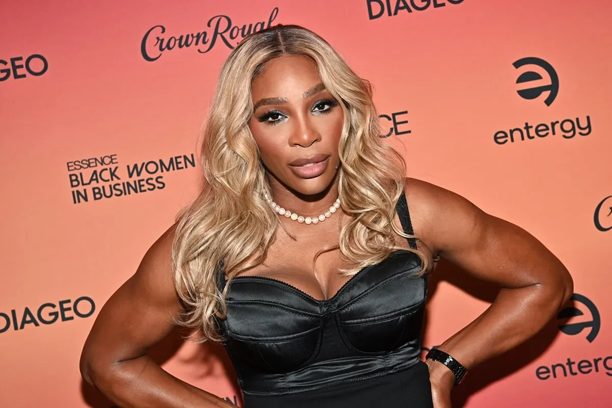 Serena Williams wearing a striped dress and smiling in Los Angeles