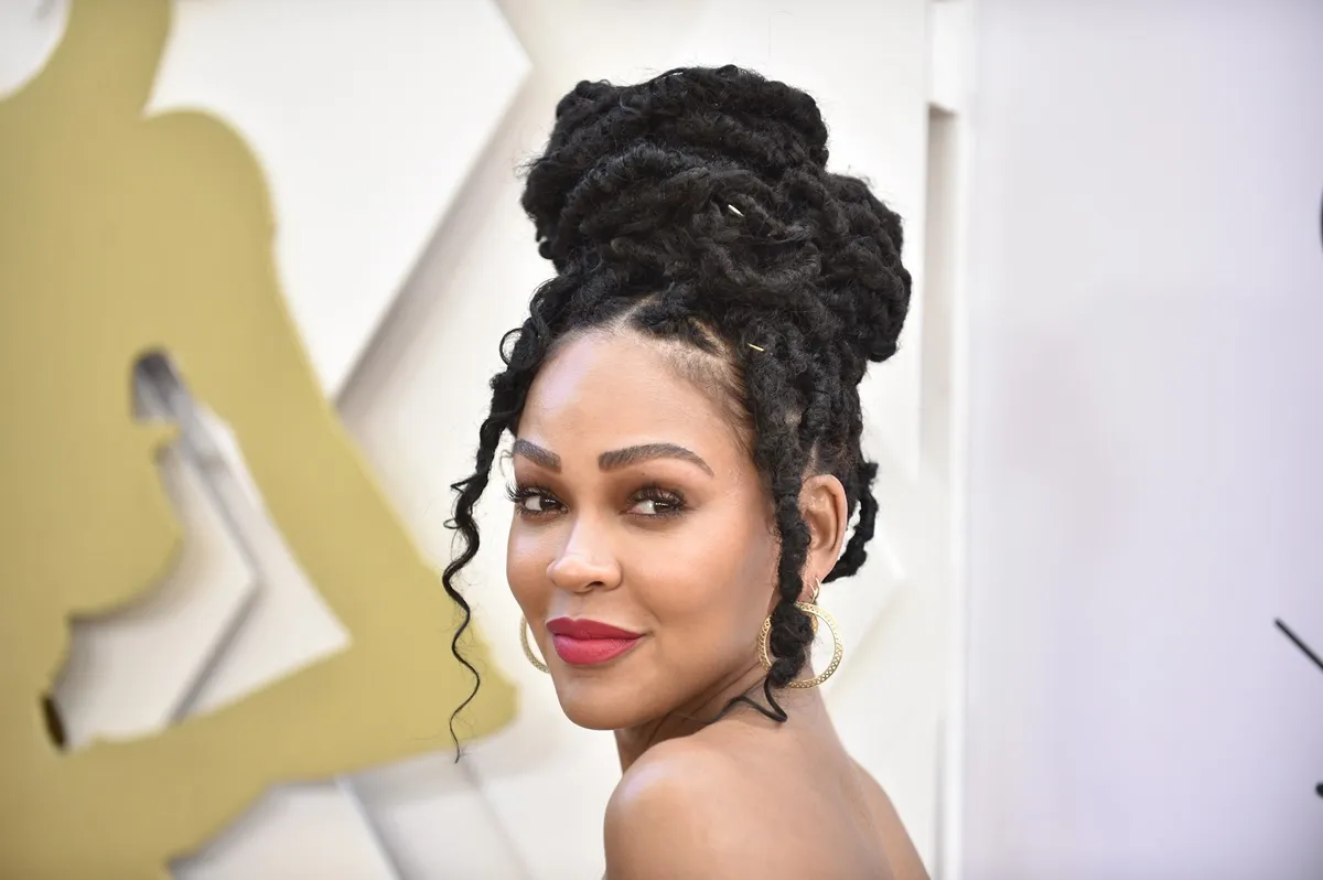 Meagan Good posing at Essence magazine in a dress.