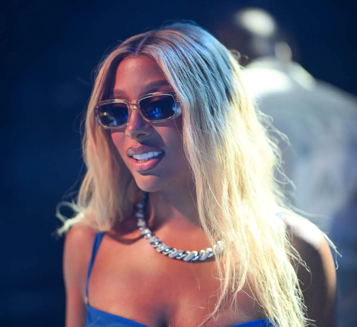 Wearing a mesh blue dress, Victoria Monét celebrates at a party in new Orleans
